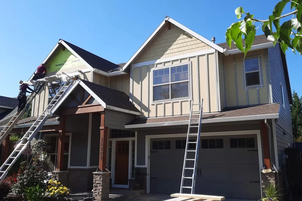 sister siding crew installing new siding on home | sister siding