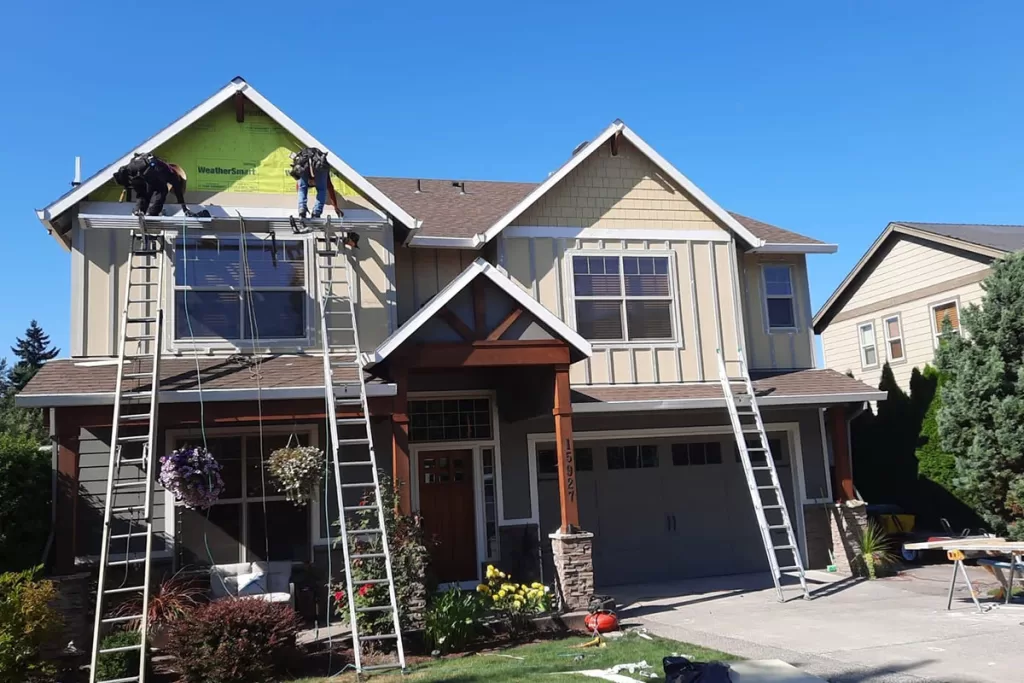 sister siding crew doing siding installation on home | sister siding