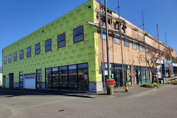 commercial-siding-1-job-completed-by-sister-siding-newberg-oregon Commercial building covered with green sheathing during renovation