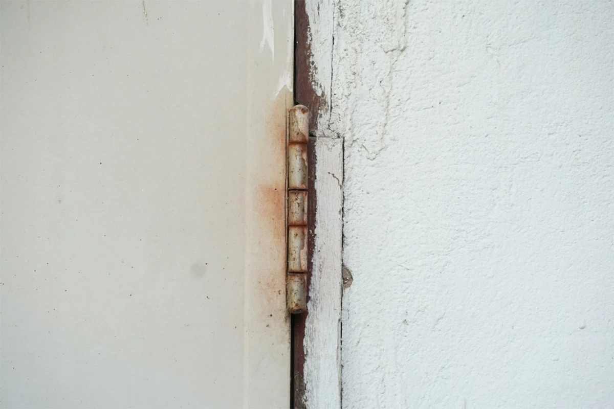 old and rusty door hinge | sister siding