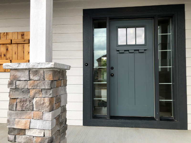 dark-teal-painted-front-door-on-white-house