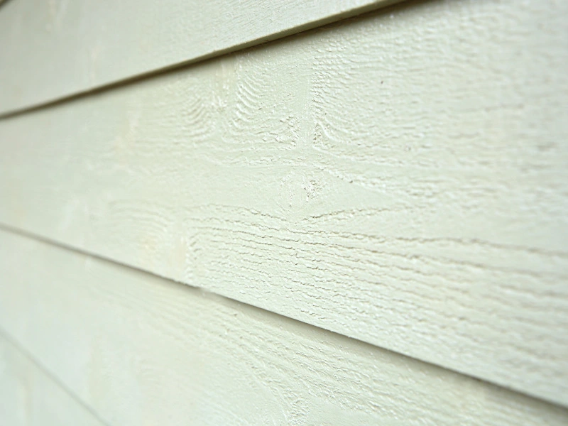 close-up-of-fiber-cement-siding-that-mimics-the-look-of-wood-siding-that-has-been-painted-over