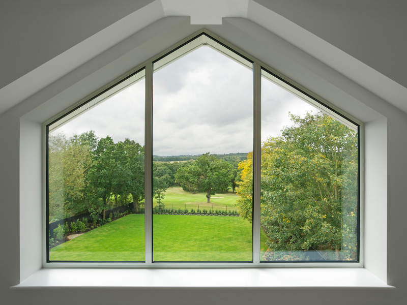 specialty-window-on-house-overlooking-backyard-and-pasture