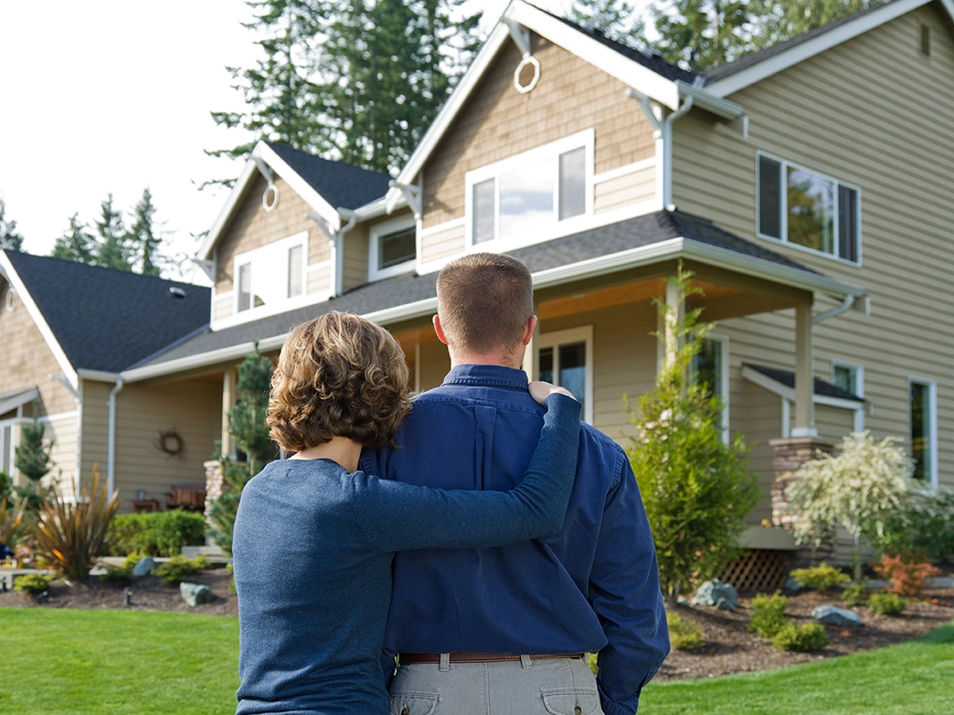 couple-looking-at-their-newly-sided-house