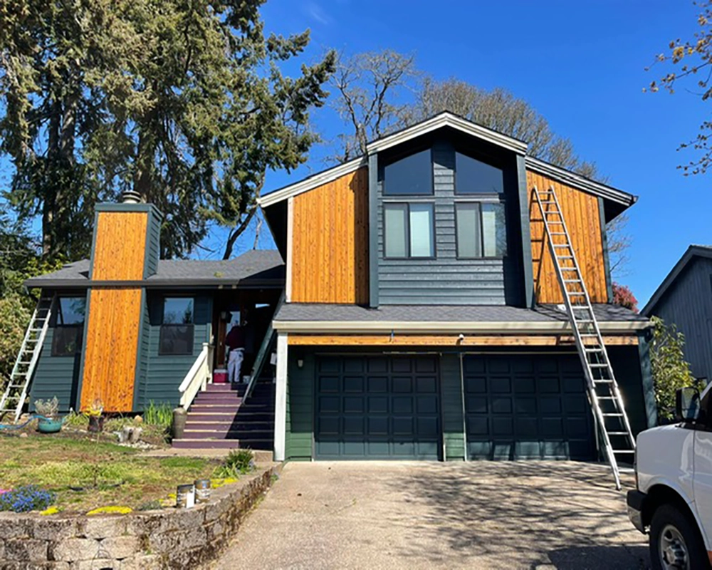 newly-sided-green-house-with-wood-accents