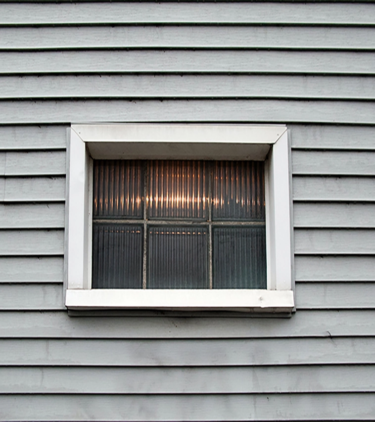 grey-vinyl-siding-with-window-in-center