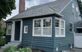 blue home with new exterior siding and painted
