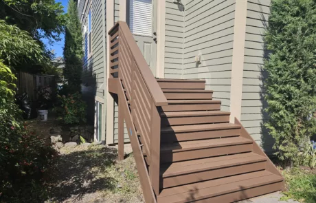 newly installed deck and steps for back door brown painted wooden stairs