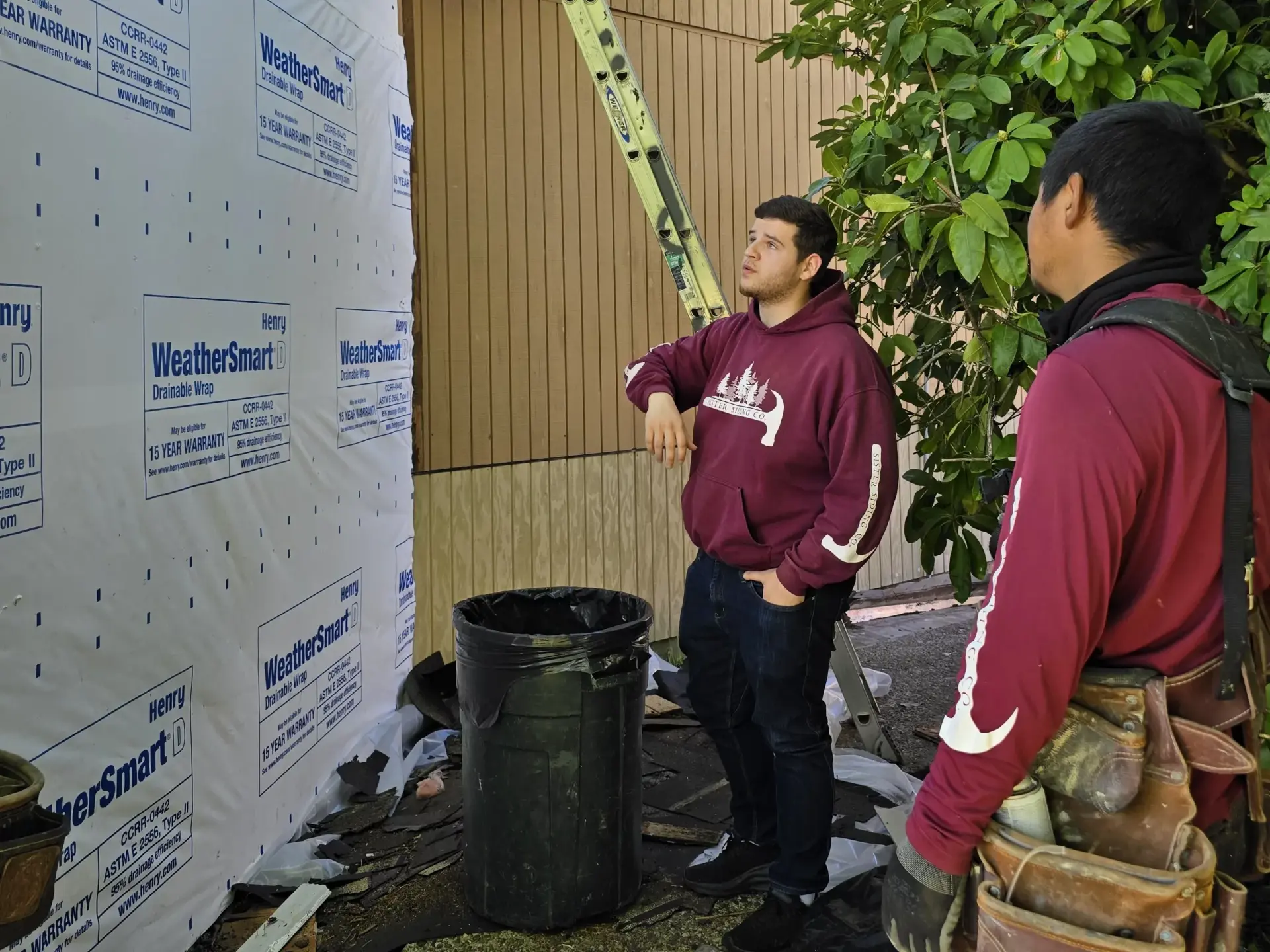 Lucas kelly inspecting house siding in newberg