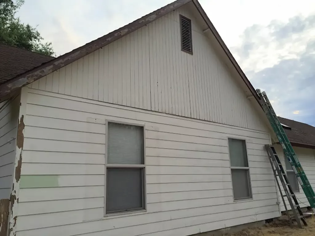 siding project before of run down white exterior siding on a single family home